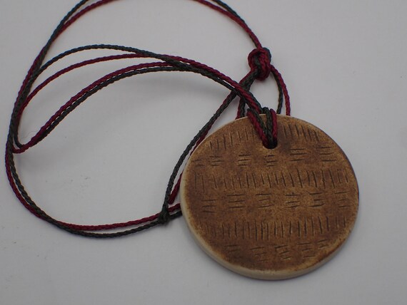 ceramic medallion, wild earth by faustine Cayol