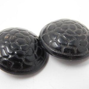 pair of black curved vintage buttons