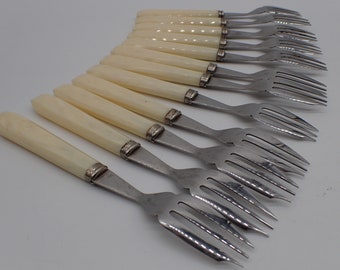 twelve place settings, vintage forks