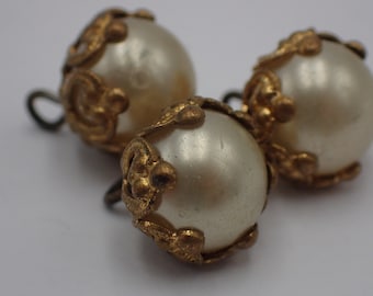 three vintage pearl buttons