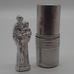 old miniature statue Saint Christopher with his case