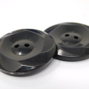 pair of black vintage buttons