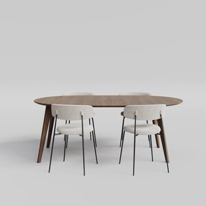 May include: An oval wooden dining table with a dark brown finish and four angled legs, accompanied by four chairs featuring off-white textured fabric seats and backrests supported by thin black metal frames arranged around the table.