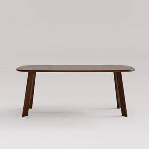 May include: A dark brown wooden table with a rectangular top and angled legs. The table has a smooth, polished surface and a minimalist design. The table is approximately 60 inches long.