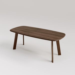May include: A rectangular wooden coffee table with a dark brown finish. The table has rounded corners and four angled legs. The table is approximately 60 inches long and 24 inches wide.