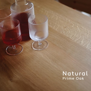 May include: A clear glass carafe and three matching ribbed glasses with stems, two of which contain a red liquid. The items are placed on a light-colored wooden surface with the text Natural Prime Oak visible in the bottom right corner.