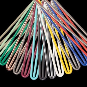 May include: A collection of 15 colourful metal rods, each with a rounded end. The rods are arranged in a fan shape, with the colours ranging from light green to red.
