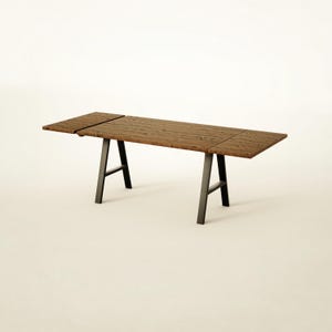May include: A rectangular dining table featuring a dark brown, textured wooden top with visible grain patterns and two extendable side leaves. The table is supported by two black metal A-frame legs connected by a horizontal support bar.