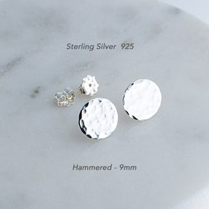 May include: A pair of sterling silver 925 hammered round stud earrings. The earrings are 9mm in diameter.