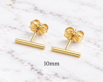 May include: A pair of gold-toned bar stud earrings with matching butterfly backs. Each earring features a horizontal bar design measuring 10mm in length. The earrings have a polished, smooth finish and are presented as a matching set of two.