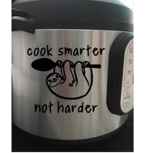 Könnte beinhalten: Ein schwarz-weißer Aufkleber mit einem Faultier, das an einem Löffel hängt. Der Aufkleber lautet "Koche intelligenter, nicht härter".