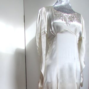 Gorgeous 1930s satin wedding dress with silver beading on neckline and beautiful full sleeves. Glamorous bias cut Art Deco gown approx UK 8