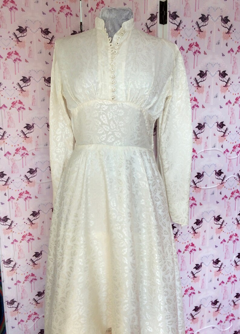 Vintage wedding dress 1950s glowing ivory damask satin with high neckline long sleeves and Hi-Lo hem. Dainty little collar & floral buttons. image 6