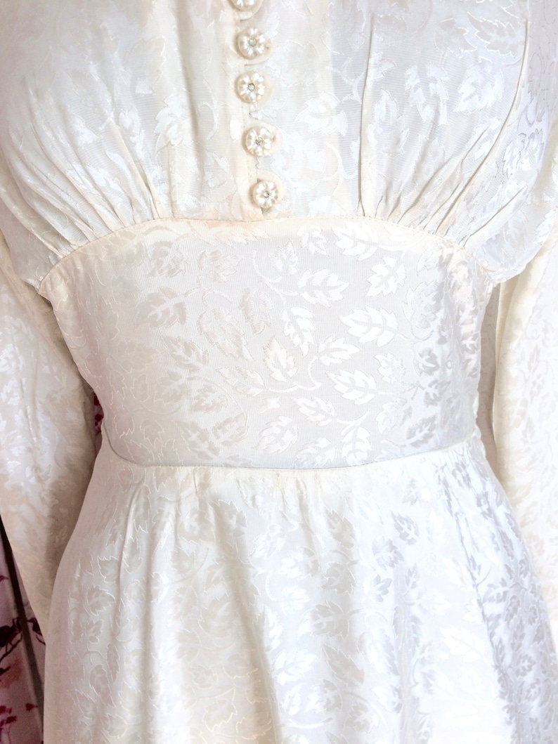 Vintage wedding dress 1950s glowing ivory damask satin with high neckline long sleeves and Hi-Lo hem. Dainty little collar & floral buttons. image 3