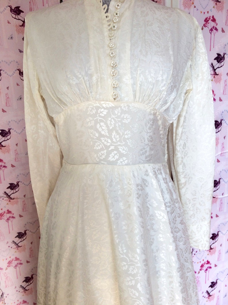 Vintage wedding dress 1950s glowing ivory damask satin with high neckline long sleeves and Hi-Lo hem. Dainty little collar & floral buttons. image 7