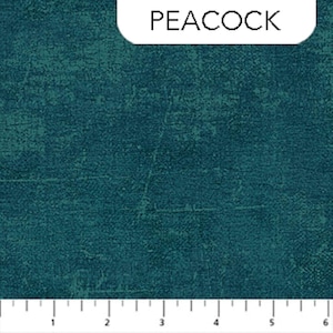 May include: Teal fabric with a textured, distressed appearance. The word "PEACOCK" is printed in white on a white rounded rectangle in the upper portion of the image. The fabric has a ruler along the bottom edge.