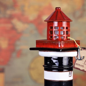 High-quality handmade ceramic lighthouse nautical themed table lamp, made as an authentic model of the Klaipeda lighthouse, Lithuania. The LED lamp at the top of the ceramic lighthouse.