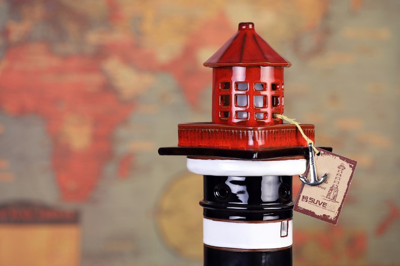 High-quality handmade ceramic lighthouse nautical themed table lamp, made as an authentic model of the Klaipeda lighthouse, Lithuania. The LED lamp at the top of the ceramic lighthouse.