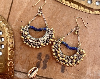 Gold Indian earrings with a small mismatched blue ceramic elephant