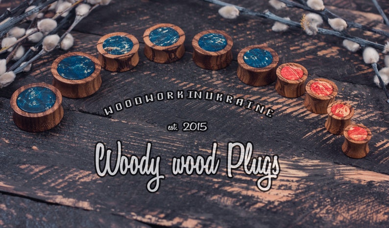 May include: A collection of wooden plugs with decorative tops. Some plugs have blue and white marbled designs, while others feature red and orange patterns. The image includes the text "Woodwork in Ukraine" and "Woody wood Plugs."