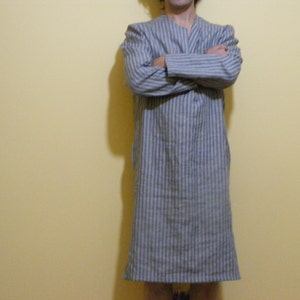 May include: A long-sleeved, blue and white striped robe with a V-neck.