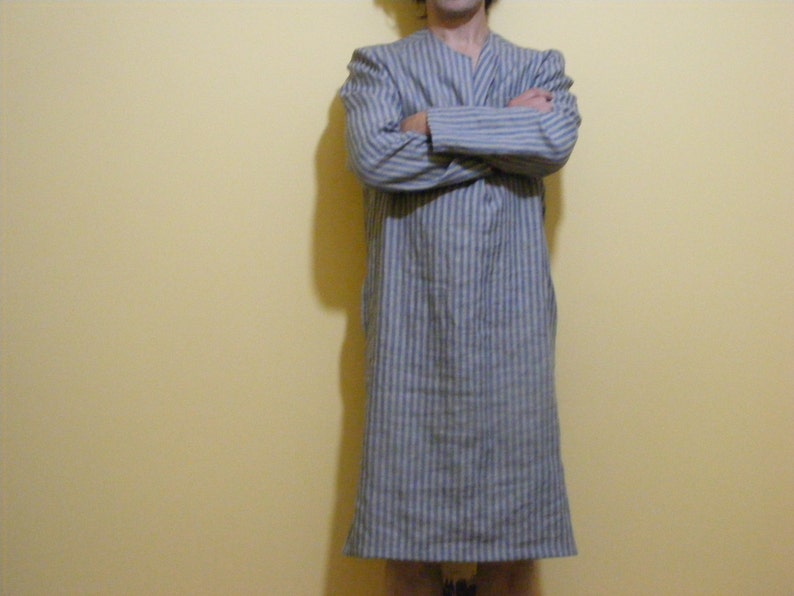 May include: A long-sleeved, blue and white striped robe with a V-neck.