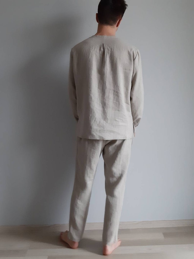 May include: A beige linen pajama set with long sleeves and pants. The set is made of a soft, breathable fabric and is perfect for lounging around the house.