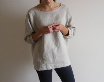 Oversize linen top with chest pocket and 3/4-length sleeves.