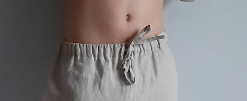 May include: A pair of light beige linen pants with a drawstring waist.