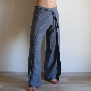 May include: Gray wrap pants with a tie at the waist.