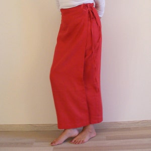 May include: A long, red wrap skirt with a tie at the waist.