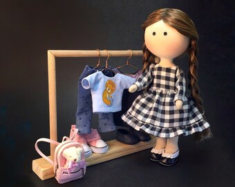 Portrait doll with pigtails in checkered dress as birthday gift for 10 years girl. Handmade soft Tilda doll with extra outfits