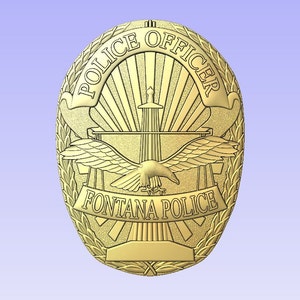 May include: A gold-colored police badge with the words "Police Officer" and "Fontana Police" on it. The badge features a stylized eagle with wings spread, a rising sun, and a tower.