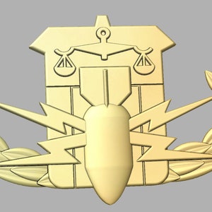 May include: A gold-colored military badge with a bomb, lightning bolts, and scales of justice. The badge is surrounded by a wreath of leaves.