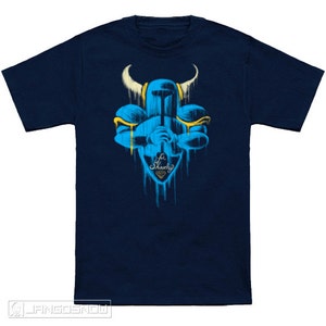 May include: A navy blue t-shirt with a blue and yellow graphic of a knight holding a sword. The graphic is dripping with paint and has the text "For Shovelry" with a diamond.