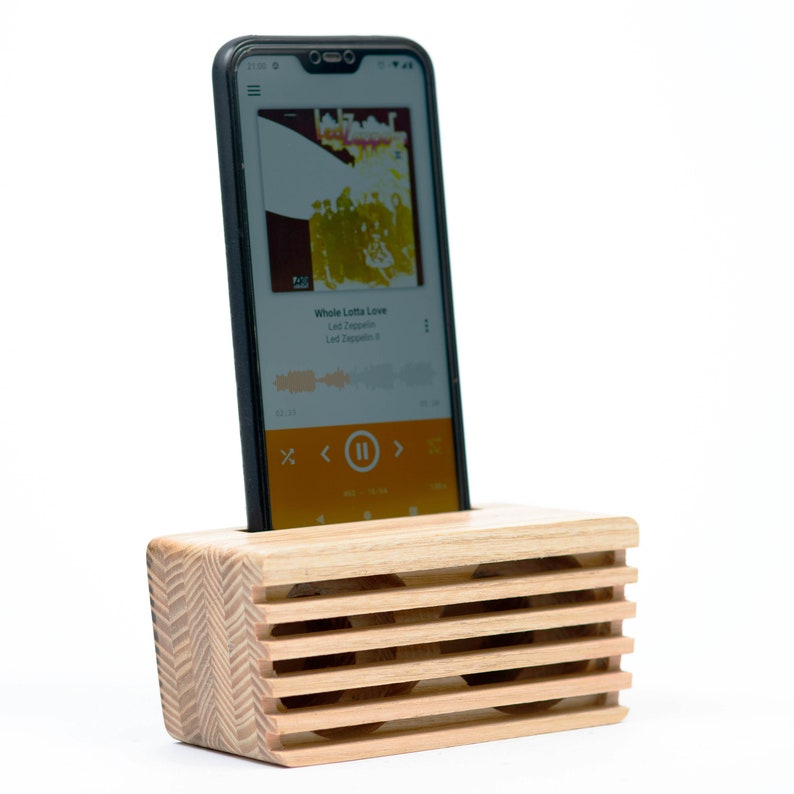 Natural color untoned (yellow) wood phone speaker with phone within