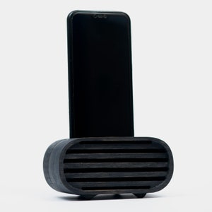 Black toned speaker with phone in it