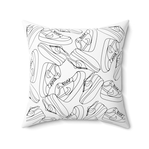 May include: White square throw pillow with a repeating black line drawing pattern of sneakers. The sneakers are depicted in a minimalist, continuous line style, creating a modern and graphic design.