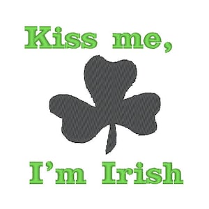 May include: Green text on a white background reads "Kiss me, I'm Irish". A black shamrock is centered between the two lines of text.