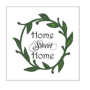 May include: A green leafy wreath with the text "Home Sweet Home" in black cursive font.