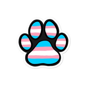 May include: A paw print sticker with a transgender pride flag design. The paw print is outlined in black and filled with alternating stripes of light blue, white, and pink.