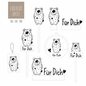 Pode incluir: Arquivos de design de corte a laser em preto e branco para um urso com bolinhas e o texto "Für Dich" (alemão para "para você"). O design está disponível nos formatos SVG, DXF e PNG.