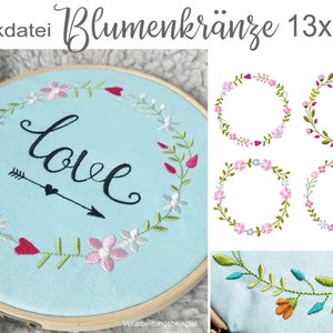 May include: Embroidery pattern for a floral wreath with the word "love" in the center. The wreath is made of pink, white, and green flowers. The pattern is 13 inches by 18 inches.
