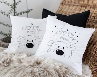 May include: Two white pillow covers with black embroidery. The pillows feature a cartoon bear with the text "Love you bear much!" on each pillow.