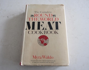 May include: A white cookbook with a red and black title: "The Complete Round the World Meat Cookbook". The author is Myra Waldo. The cover features a world map with a red outline.