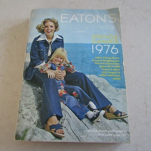May include: A vintage Eaton's catalog cover from 1976 featuring a mother and daughter wearing denim outfits. The catalog advertises "Spring & Summer 1976" and includes information about pricing terms, account shopping, and general information.