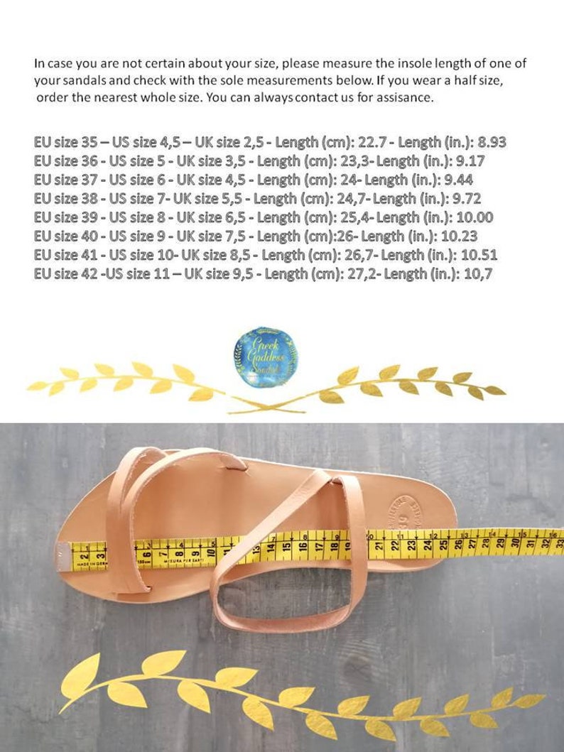 May include: A close-up of a tan leather sandal with a measuring tape showing the insole length is 27.2 cm or 10.7 inches. The text on the image reads: "In case you are not certain about your size, please measure the insole length of one of your sandals and check with the sole measurements below. If you wear a half size, order the nearest whole size. You can always contact us for assisance. EU size 35 - US size 4,5 - UK size 2,5 - Length (cm): 22.7 - Length (in.): 8.93 EU size 36 - US size 5 - UK size 3,5 - Length (cm): 23,3 - Length (in.): 9.17 EU size 37 - US size 6 - UK size 4,5 - Length (cm): 24 - Length (in.): 9.44 EU size 38 - US size 7 - UK size 5,5 - Length (cm): 24,7 - Length (in.): 9.72 EU size 39 - US size 8 - UK size 6,5 - Length (cm): 25,4 - Length (in.): 10.00 EU size 40 - US size 9 - UK size 7,5 - Length (cm): 26 - Length (in.): 10.23 EU size 41 - US size 10 - UK size 8,5 - Length (cm): 26,7 - Length (in.): 10.51 EU size 42 - US size 11 - UK size 9,5 - Length (cm): 27,2 - Length (in.): 10,7"