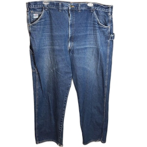 May include: A pair of dark blue denim work jeans featuring a classic five-pocket design, a button fly closure, and a utility loop on the side. The fabric shows a slight faded wash on the thighs and includes a small rectangular brand label.