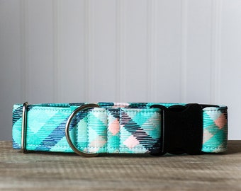 May include: A turquoise, pink, and black patterned dog collar with a silver D-ring and a black plastic buckle.