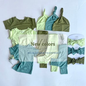 May include: A flat lay of green, light green, and teal clothing items, including t-shirts, leggings, and headbands. The text "New colors" and "Reimagined Features" is displayed on the image.